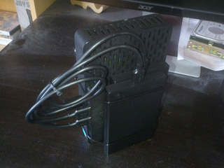 A Dell N06D thin client, a USB 3.0 hub and two 2.5" SATA caddies cable tied together.